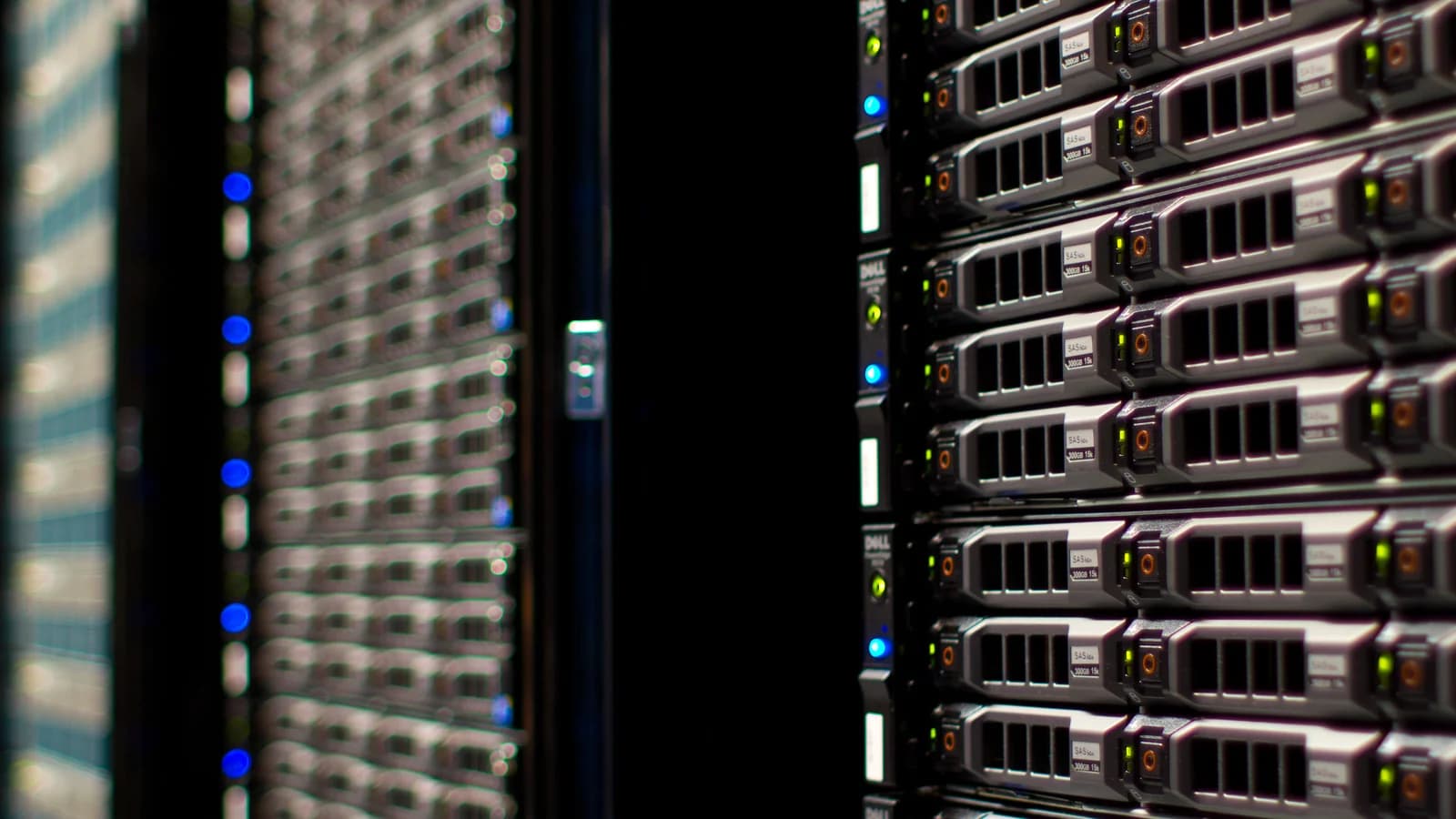 Rows of rack-mounted servers in a data centre, lit by status LEDs