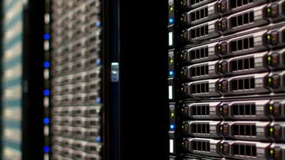 Rows of rack-mounted servers in a data centre, lit by status LEDs